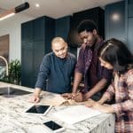 three business owners looking at plans